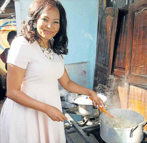 HELPING HANDS: Siba Mtongana, cooking for kids at the launch in Alexandria township Picture: SUPPLIED