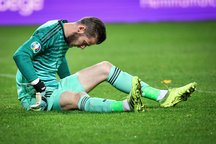 Spain goalkeeper David de Gea reacts after getting an injury