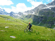 Francois Lombard tackles a verdant Alpine hillside on an electric bike. 