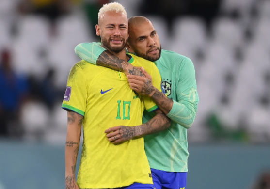 Neymar of Brazil is consoled by Dani Alves after the loss via a penalty shootout during the FIFA World Cup Qatar 2022 quarter final match against Croatia at Education City Stadium on December 09, 2022 in Al Rayyan, Qatar.