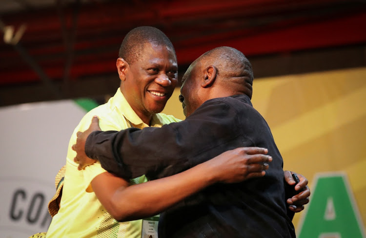 Re-elected ANC president Cyril Ramaphosa congratulates Paul Mashatile, the newly elected deputy president, at the party's 55th national conference at Nasrec in Johannesburg on December 19 2022.