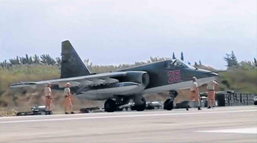 SYRIAN COMPLICATION: A frame grab taken from footage released by Russia’s Defence Ministry on Monday shows technicians gathering around a Russian air force SU-25 military jet on the tarmac of Heymim air base in Syria. More than 40 Syrian insurgent groups have called on regional states to forge an alliance against Russia and Iran in Syria, accusing Moscow of occupying the country and targeting civilians Picture: REUTERS