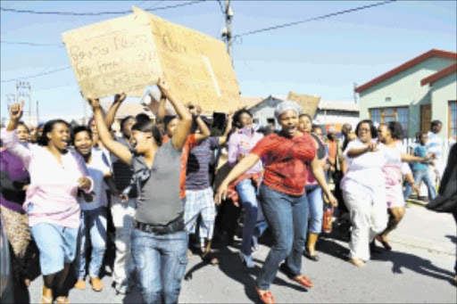 AWAY WITH COUNCILLOR: Ithembalabantu housing project beneficiaries protesting on the streets of Makhaza, Khayelitsha, Cape Town, against their councillor, Danile Khatshwa, who allegedly stopped construction on a new housing project in the area. PHOTO: UNATHI OBOSE