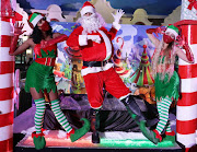 Socially distanced Santa Keegan Mitchell with elves Nicola Pharo and Jenny Umbhau greets visitors at GrandWest in Cape Town on December 23 2020. Christmas definitely came bang on time for a number of lottery winners, whose names are withheld, who will be enjoying their new lives and helping others enjoy a merry Christmas too. 