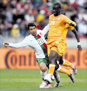 MIDFIELD MISMATCH: Ivory Coast midfielder Yaya Toure fights for the ball with Portugal's Deco during their World Cup clash in Rustenburg on Tuesday. 17/06/2010. © Unknown.