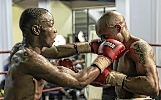 Rofhiwa Maemu, left, pummels Tumelo Pedi on his way to the Gauteng featherweight title. The former ABU and WBA champion announced he has rejoined long-time trainer Anton Gilmore.