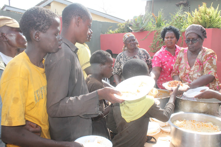 Kaloleni MCA Prisca Auma servers lunch to street children during a New Year event in her Arina home in 2017