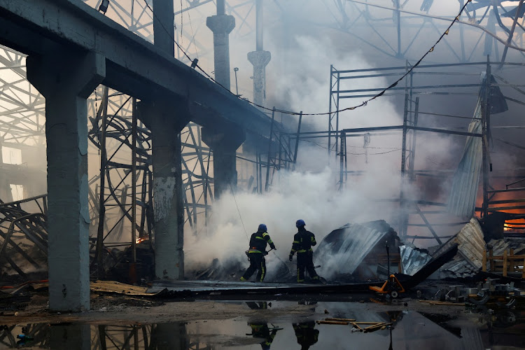 Firefighters work at a site of a warehouse heavily damaged during a Russian missile strike, amid Russia's attack on Ukraine on December 29 2023. Picture: VALENTYN OGIRENKO/REUTERS/