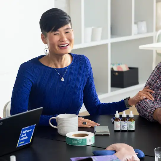 The owner and CEO of Asutra is seated with Asutra products by her side.