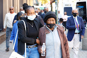 A young relative, Setsabile Vilakazi, helps Nokuthula Simelane's mother Msesi Simelane as they leave court.