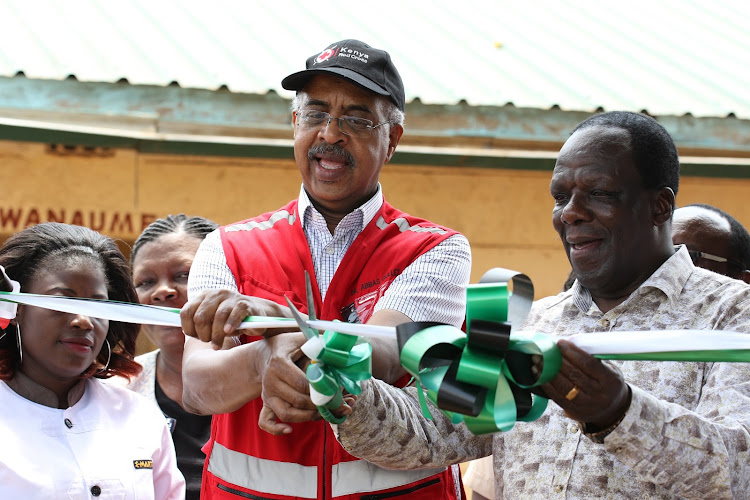 Kenya Red Cross secretary general Abass Gullet and Kakamega Governor Wycliffe Oparanya commissioning the Misango water project in Khwisero sub-county on Friday