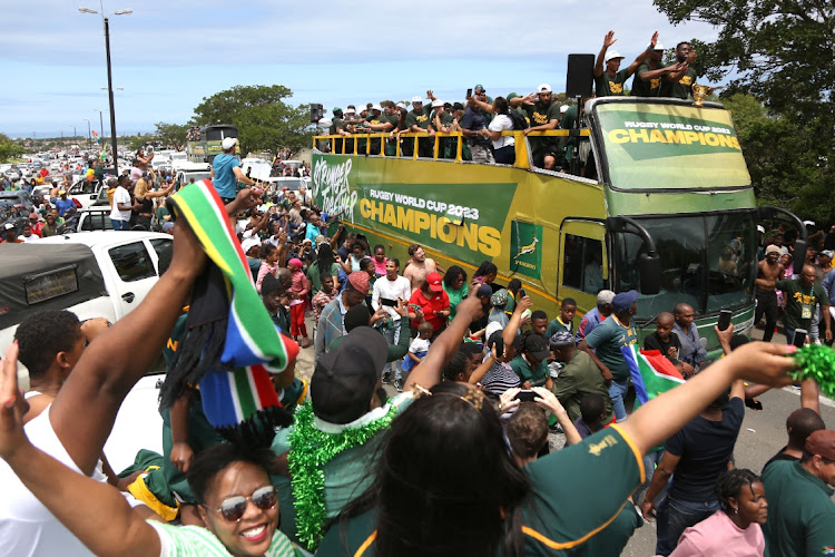 Supporters throng around the Springboks’ bus as they drive down Amalinda Main Road during the East London leg of their national tour celebrating their Rugby World Cup victory.