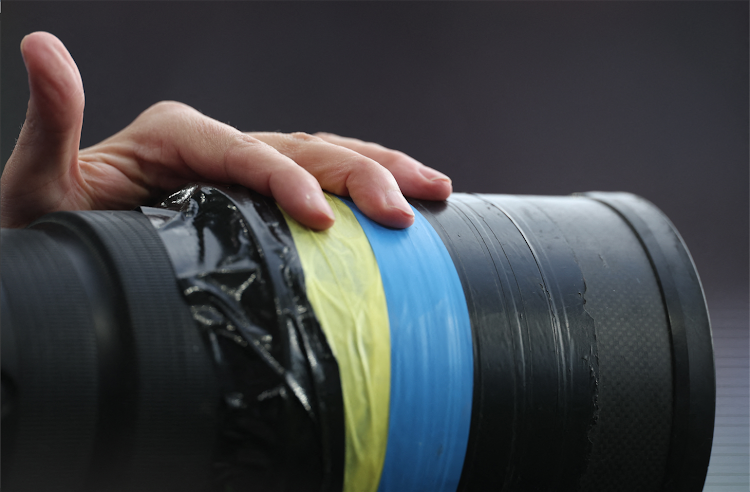 General view of a photographer's camera lens with yellow and blue tape wrapped it in support of Ukraine amid Russia's invasion during the match