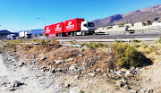 Trucks pass the scene of Sunday's looting in De Doorns.