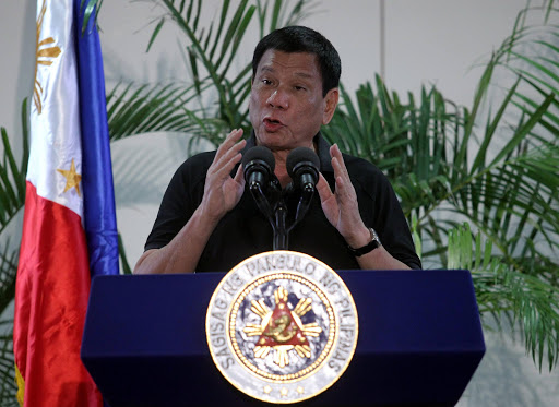 Philippines President Rodrigo Duterte gestures during a news conference upon his arrival from a state visit in Vietnam at the International Airport in Davao city, Philippines September 30, 2016. REUTERS/Lean Daval Jr