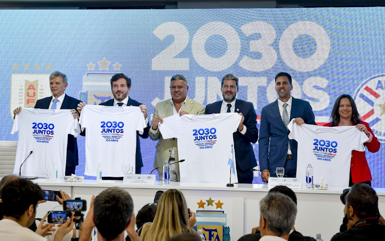 Left to right, secretary of sports of Uruguay Sebastian Bauza; president of the South American Football Confederation Alejandro Domínguez, president of Argentine Football Association Claudio Tapia; Argentinian sports minister Matias Lammens, Paraguayan sports minister Diego Galeano Harrison and Chilean sports minister Alexandra Benado Vergara pose with T-shirts during a press conference to officially announce the countries' joint bid for Fifa 2030 World Cup, in Ezeiza, Argentina, February 7 2023. Picture: MARCELO ENDELLI/GETTY IMAGES