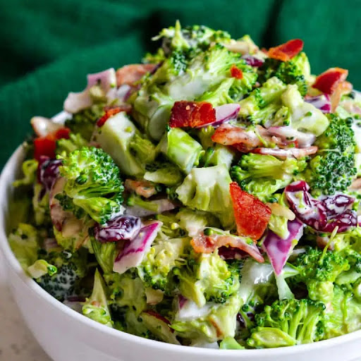 A family-friendly, easy broccoli salad recipe with crisp bacon, onions, sliced almonds, dried cranberries, and a lightly sweetened, easy four-ingredient dressing.  This broccoli salad comes together in about 10-15 minutes and is perfect for potlucks, fami