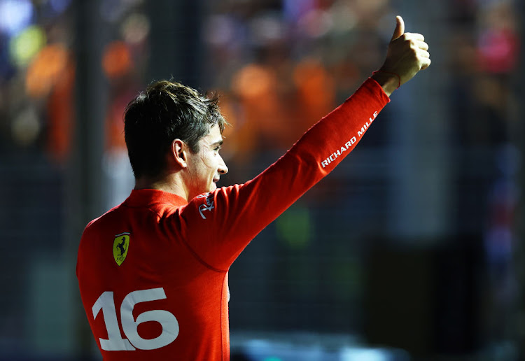 Pole position qualifier Charles Leclerc celebrates in parc ferme during qualifying ahead of the F1 Grand Prix of Singapore at Marina Bay Street Circuit on October 01, 2022 in Singapore, Singapore.