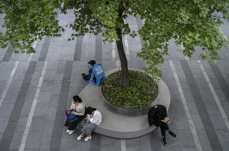 People sit on a bench in a retail shopping area on April 18, 2023 in Beijing, China. China’s China’s National Bureau of Statistics reported 4.5 percent GDP growth in the first quarter of 2023 over a year ago, as the world’s second largest economy showed signs of growth after ending three years of strict zero Covid measures earlier this year. In March, total retail sales went up by 10.6% year on year, according to data released.