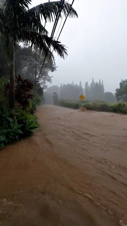 A flooded road is seen near the breached Kaupakalua dam, in Haiku on Maui, Hawaii, U.S. March 8, 2021 in this still image from social media video.