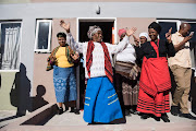 Nonikile Zazeka, 87, celebrates after being given a flat in Delft, Cape Town.