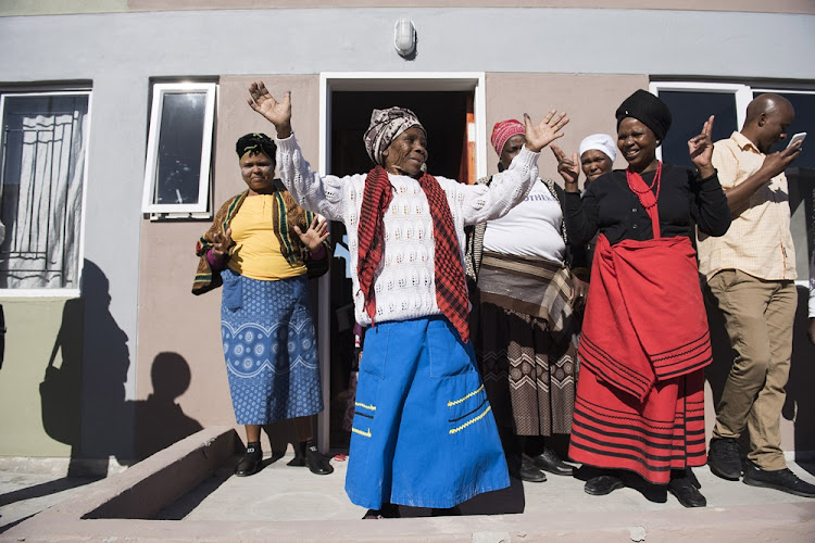 Nonikile Zazeka, 87, celebrates after being given a flat in Delft, Cape Town.