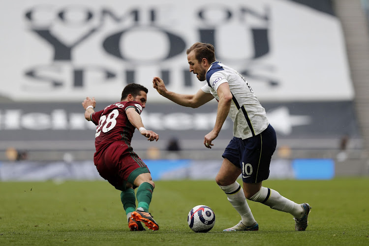 Harry Kane of Tottenham Hotspur is challenged by Joao Moutinho of Wolves in the Premier League match at Tottenham Hotspur Stadium on May 16, 2021 in London