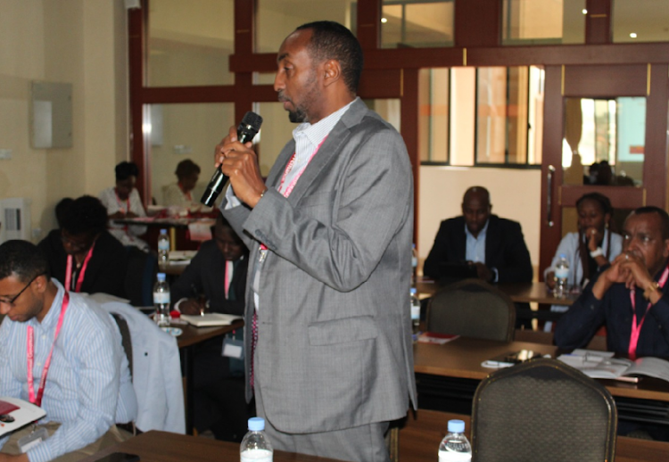 EACC Deputy CEO Abdi Mohamud address delegates during the summit in Kigali, Rwanda.