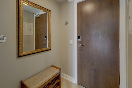 entrance with bench and decorative mirror in this luxury apartment / penthouse for sale in Calgary ($190,525)