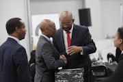 Advocate Dali Mpofu talks to former Sars commissioner Tom Moyane at the state capture inquiry in Parktown, Johannesburg.