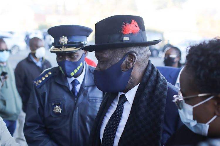 Police minister Bheki Cele (centre) speaks to people before receiving the Covid-19 vaccine at Orlando Stadium in Soweto, Johannesburg, on July 5 2021.