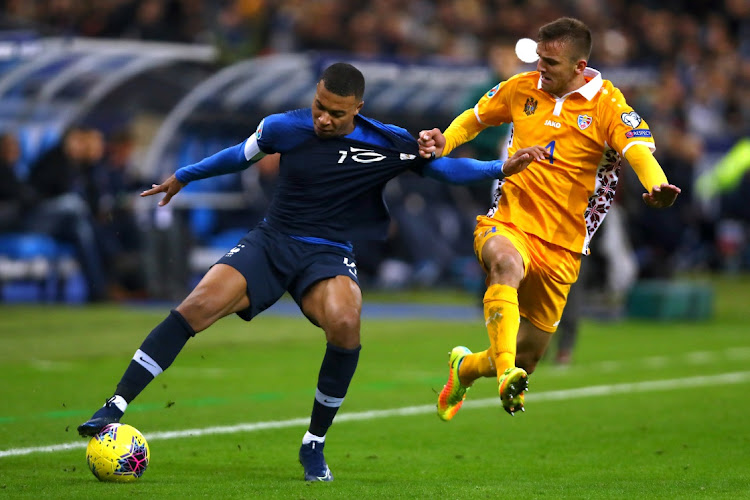 Kylian Mbappé of France, left, is challenged by Sergiu Platica of Moldova during a match in Paris. The French superstar’s inclusion in the country’s Olympic team may be hindered by the late finish of the Uefa Euro Championships