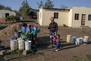 Lina Nkosi plays with her grandchild in the yard of her house in Jozini in northern KwaZulu-Natal.