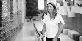 Founder Kasia Dorsey stands along a railing outdoors.