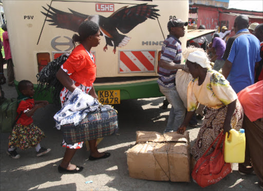 EXODUS: Some of the families fleeing Naivasha ahead of the Saba Saba rally wait for buses at the Nakuru bus terminus.