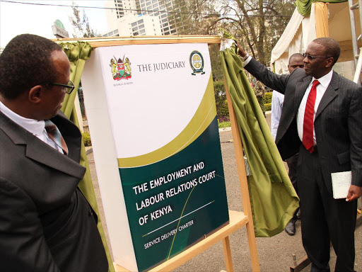 Former Chief Justice Willy Mutunga and Industrial court Judge Nduma Nderi during the launch of the Employment and labour relations Court service Charter at Milimani law court. /FILE