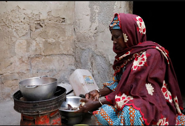 Astou Mandiang cooks the meal for her family, for the breaking of the Muslim fast during the holy month of Ramadan at her home in Dakar, Senegal April 11, 2022