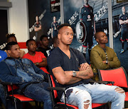 New Orlando Pirates goalkeeper Brilliant Khuzwayo is pictured sitting in front of his fellow Bucs' recruits. 