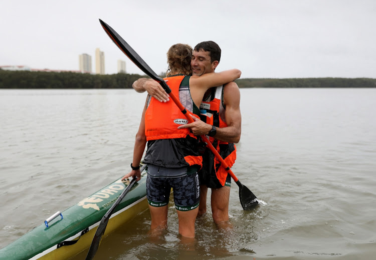 Andy Birkett and Abby Solms celebrate after winning the men's and women's races in the 2024 Dusi canoe marathon