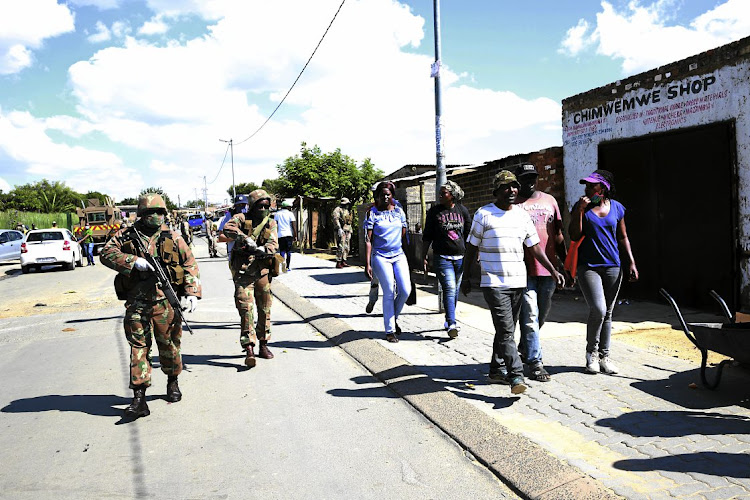 Masked, gloved and armed soldiers patrol the streets of Diepsloot, where people are said to be ignoring many lockdown measures put in place to help slow infection rates of the Covid-19 pandemic.