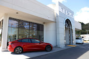 A file photograph of brand new Tesla cars at a Tesla dealership in Corte Madera, California, US.