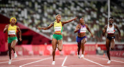 Elaine Thompson-Herah of Team Jamaica celebrates crossing the finish line to win the gold medal in the Women's 100m Final on day eight of the Tokyo 2020 Olympic Games at Olympic Stadium on July 31, 2021 in Tokyo, Japan. 