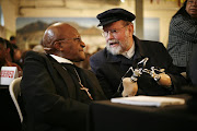 Father Michael Lapsley with Archbishop Emeritus Desmond Tutu. Lapsley, an Anglican priest and activist, lost his hands and one eye when a letter bomb hidden by apartheid agents among religious magazines exploded in his face in 1990.