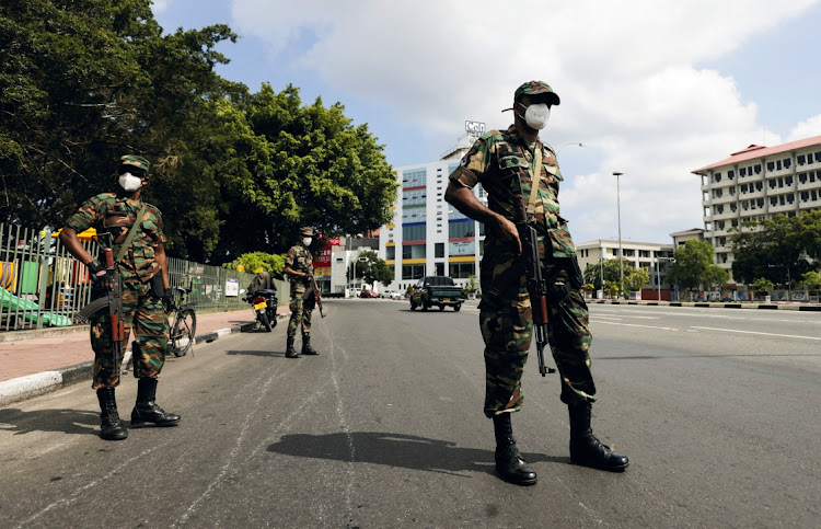 Sri Lankan army soldiers stand guard at a checkpoint after the government imposed a curfew following a clash between police and protestors near Sri Lankan President Gotabaya Rajapaksa's residence during a protest last Thursday, amid the country's economic crisis, in Colombo, Sri Lanka, April 3 2022. Picture: DINUKA LIYANAWATTE/ REUTERS