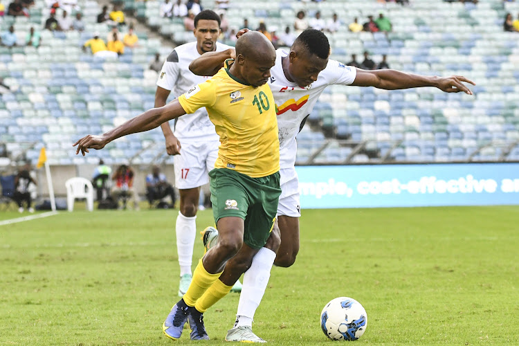 SA's Percy Tau and Rodrigue Kossi of Benin during the 2026 Fifa World Cup qualifier at Moses Mabhida Stadium in Durban, November 18 2023. Picture: GALLO IMAGES/ DARREN STEWART