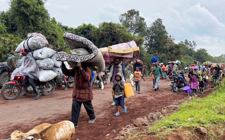 Congolese civilians flee near the border with Rwanda after fighting broke out in Kibumba, outside Goma, in May last year.