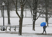 A pedestrian walks through Boston Common during a winter snow storm in Boston, Massachusetts, on January 17 2018. 