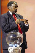 THE DRAW: Jomo Sono holds the card for Namibia during the preliminary draw for the 2010 World Cup. Pic. Mike Hutchings. 25/11/07. © Reuters

THE DRAW: Jomo Sono holds the card for Namibia during the preliminary draw for the 2010 World Cup tournament in Durban.