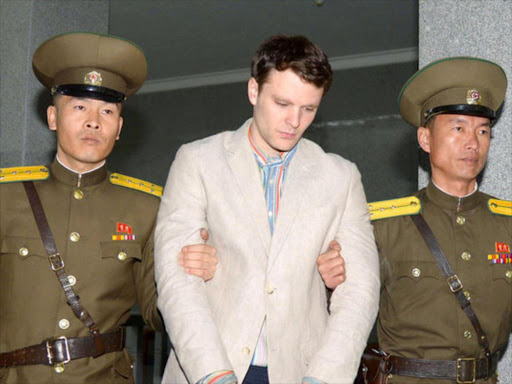 Otto Frederick Warmbier (C), a University of Virginia student who was detained in North Korea since early January, is taken to North Korea's top court in Pyongyang, North Korea, in this photo released by Kyodo March 16, 2016. /REUTERS/Kyodo