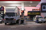 The SAPS cordon off the scene of a robbery at the Caltex filling station in Cape Road. Pierre Potgieter, who chased after the suspects, died in hospital on Wednesday.